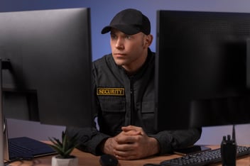 Successful security company owner sitting behind his desk